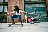 Family riding skateboards on sidewalk