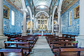 Ornate arches and pews in Iglesia de Santa Maria, Obidos, Leiria, Portugal