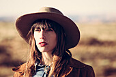 Portrait of Young Adult Woman in Cowboy Hat and Red Lipstick