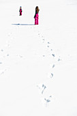 girl and boy trudging through the snow in winter, Pfronten, Allgaeu, Bavaria, Germany