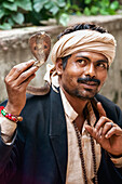 Snake charmer carrying cobra, New Delhi, Delhi, India