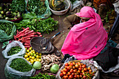 Vegetable vendor sitting on a street, Pushkar, Rajasthan, India