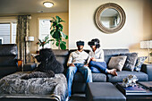 Couple using virtual reality goggles
