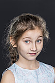 Portrait of confident girl over gray background