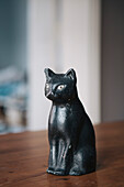 Bronze statuette of black cat on table