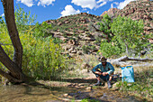Filtering water on a creek in Desolation Canyon along the Green River, Utah.