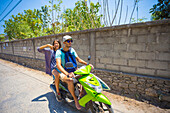 Happy young couple on motorbike