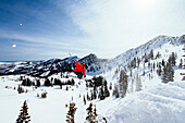 A man skiing off a cliff in the Alta, Utah, Backcountry.