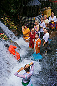 Balinese ceremony in waterfall, Bali, Indonesia.