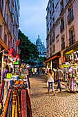 Street with souvenir shops on Montmartre with the Basilica Sacre-Coeur in the background, Paris, France, Europe