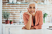 Older Caucasian woman smiling in kitchen