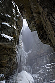 View from Breitachklamm to steep rock walls in Winter with snowfall and icicles, Obersdorf, Germany 2014