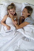 Mother and daugther lying in bed together