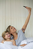 Mother and daughter posing for selfie