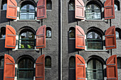 orange shutters typical of the black buildings, amsterdam, holland