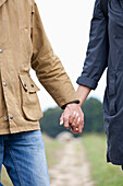 Young couple holding hands, close-up