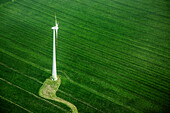 High angle view of wind turbine on green landscape