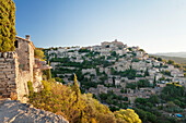 Hilltop village of Gordes with castle and church at sunrise, Provence, Provence-Alpes-Cote d'Azur, France, Europe