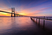 The colors of dawn on Vasco da Gama Bridge that spans the Tagus River, Lisbon, Portugal, Europe