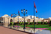 Polished pavements, National Flags, lush lawns and flowers in bloom, Sultan's Palace, Old Muscat, Oman, Middle East
