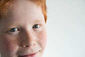 Boy with red hair and freckles, close-up portrait