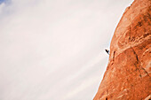 A woman climbs a cliff near Moab, Utah.
