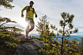 Trail runner on the granite rocks of the White Mountains of New Hampshire.