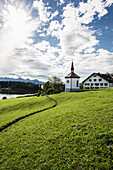 Hegratsrieder See, with traditional farmhouse and chapel, near Füssen, Bavaria, Germany