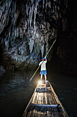Thai man with punting through Tham Lot cave, Thailand, Southeast Asia
