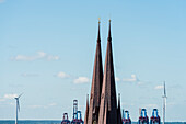 The towers of Saint Peter church in Altona with cranes of the container terminal Burchardkai in the Hamburg harbour in the background, Hamburg, Germany
