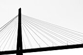 The fan-shaped reverse bracings, the lighting and the pylon of the sloping rope bridge built in steel Köhlbrandbrücke as a silhouette, Hamburg, Germany