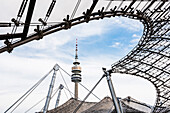 View through the famous roof of the Olympic stadium at the Olympic tower in the Olympic Park, Munich, Bavaria, Germany