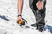 Person looking for an avalanche victim with an avalanche beacon