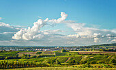 Two cloud systems connecting in arch shape over vineyards in Germany.