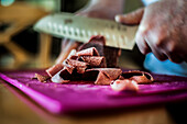 Cutting a frozen chunk of Reindeer meat, a staple in the diet of people living in Lapland