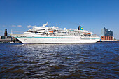 Cruise liner Amadea leaving at the harbour, view to Michel and Elbphilharmonie, Hamburg, Germany