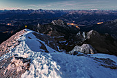 At nightfall on top of the Duerrenstein, Hiker enjoying the view towards Puster Valley, Dolomites, Unesco world heritage, Italy