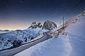 Mountain road leading to Sella mountain pass, Gardena Valley, Plattkofel and Langkofel in the background, Dolomites, Unesco world heritage, South Tyrol, Italy