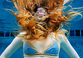 Caucasian woman underwater in swimming pool