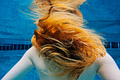 Caucasian woman underwater in swimming pool
