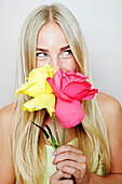 Caucasian woman smelling flowers