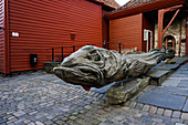 Carved wooden statue of a stock fish a type of cod, Hanseatic quarter, Bryggen, Bergen, Hordaland, Norway, Scandinavia, Europe