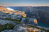 Overlooking the Lysefjord from Kjerag plateau of rocks in the morning sun, Rogaland, Norway, Scandinavia
