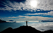 Hiker over a sea of clouds, Como lake, Lombardy, Italy