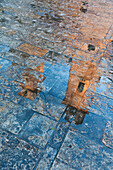 Reflection of the cathedral of St. Tryphon on the wet pavement. Kotor old city, Montenegro