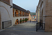Cloister in the Timios Stavros Monastery in Odomos with playing children in the evening, Cyprus