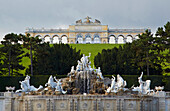 Park of Schönbrunn Castle with well Neptunbrunnen and Gloriette at Vienna on the river Danube , Austria , Europe