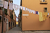 hanging lines of drying washing, across the street, Venice, Italy.