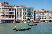 Gondolas, Gondoliers and tourists, Hotel Bauer, Palace facades, Canal Grande, Venice, Venetia, Italy.