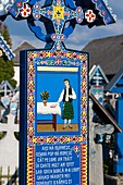 Romania, Maramures Region, Sapanta, The Merry Cemetery with handcarved gravestones with amusing stories about the departed.